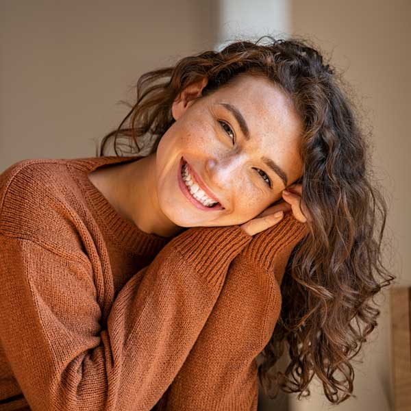 Young woman laughing while relaxing at home