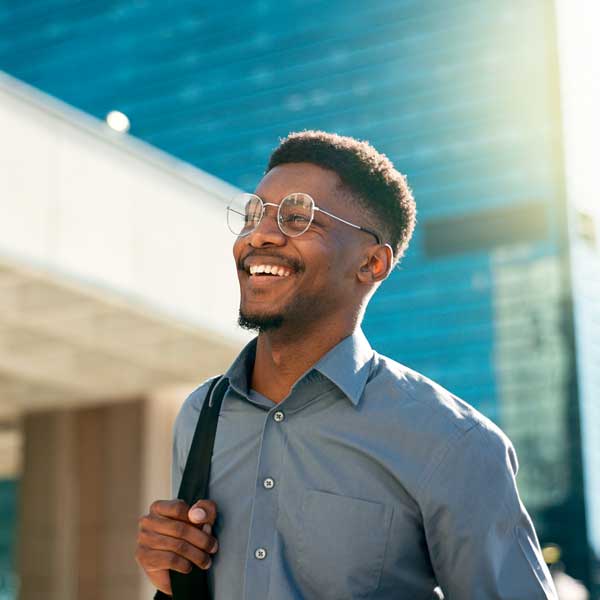 smiling man commuting through the city