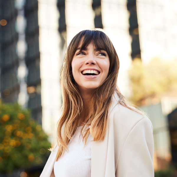 Young Professional Walks, Looking Back with a Broad Smile.