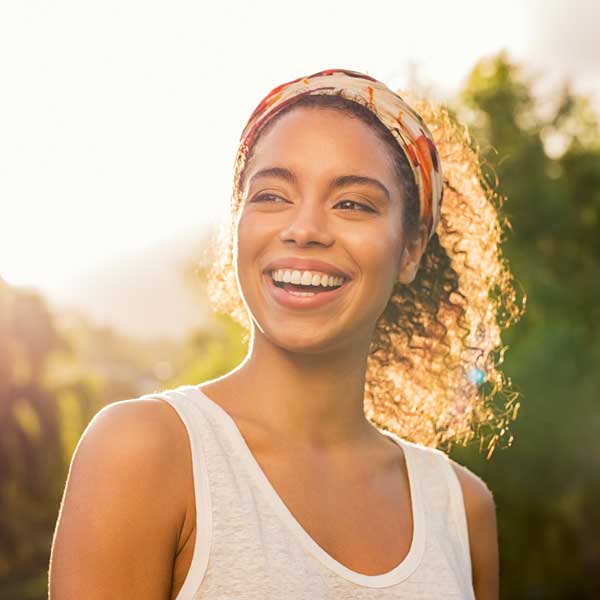 Young woman smiling at sunset